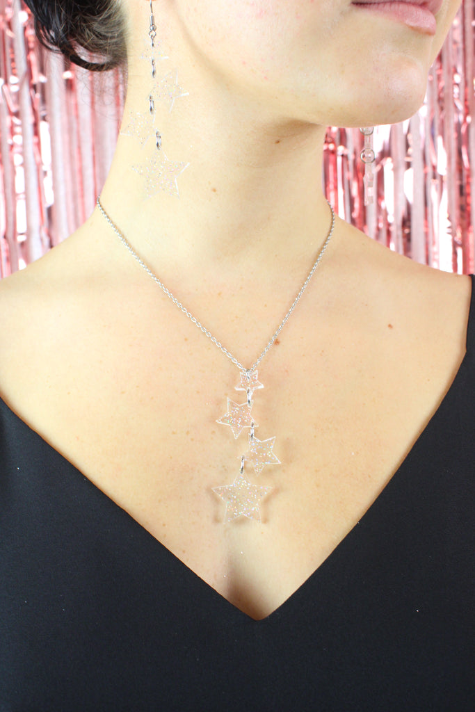 Model wearing holographic glitter star charms on a stainless steel chain