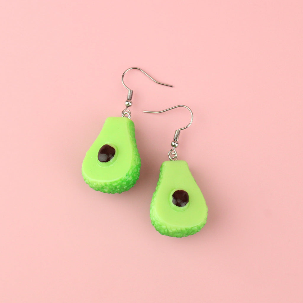 Charms showing the inside of an avocado on stainless steel earwires