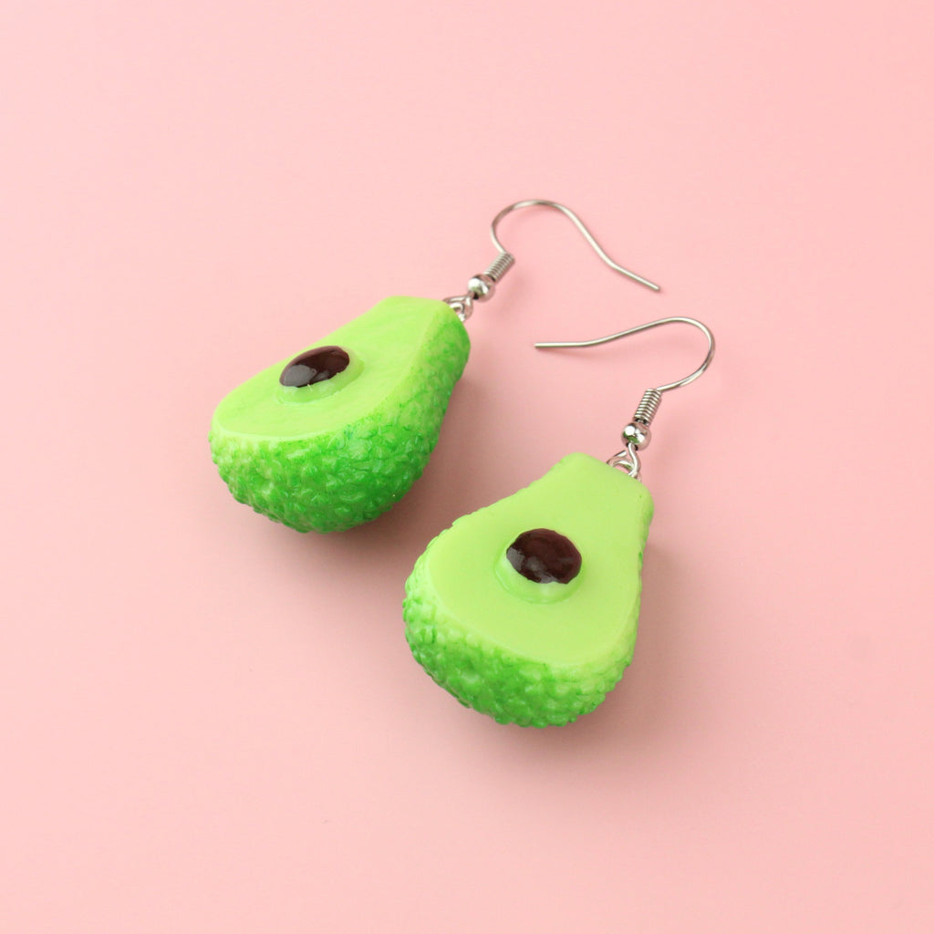Charms showing the inside of an avocado on stainless steel earwires