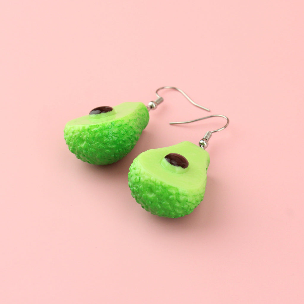 Charms showing the inside of an avocado on stainless steel earwires