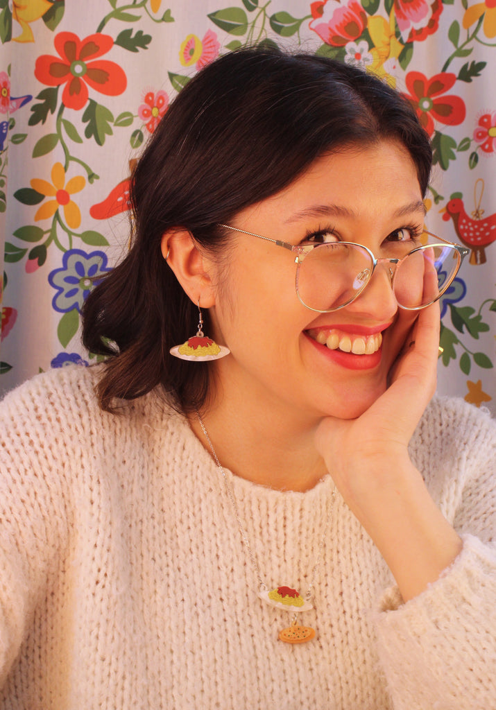 Model wearing acrylic charms that feature a delicious plate of spag bol and garlic bread on stainless steel earwires. Model is also wearing the matching necklace.