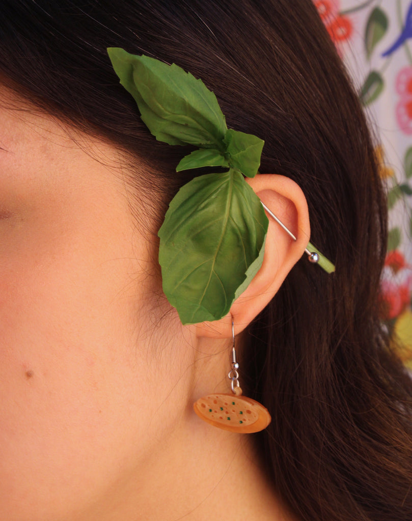 Model wearing garlic bread earring 