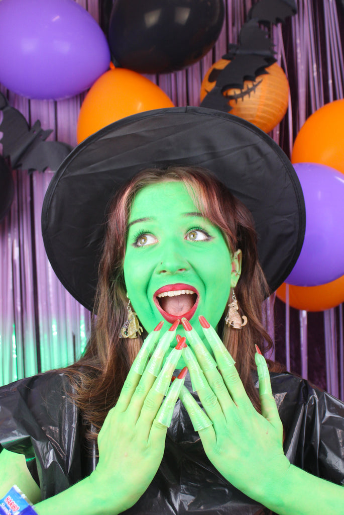 model wearing Dog charms with an extra layer of holographic glitter to replicate a ghost n stainless steel earwires