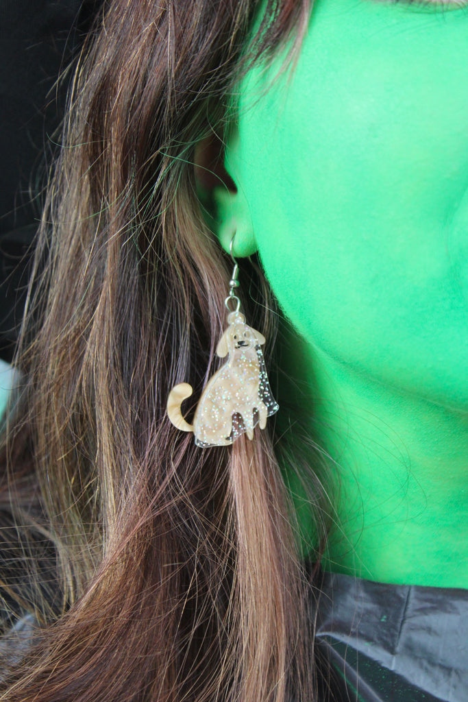 Ear wearing Dog charms with an extra layer of holographic glitter to replicate a ghost on stainless steel earwires