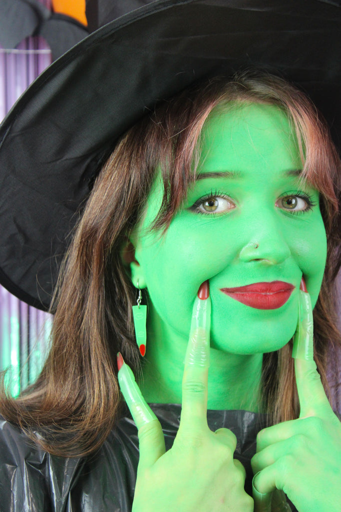 Model wearing Green witch's finger charm on stainless steel earwires