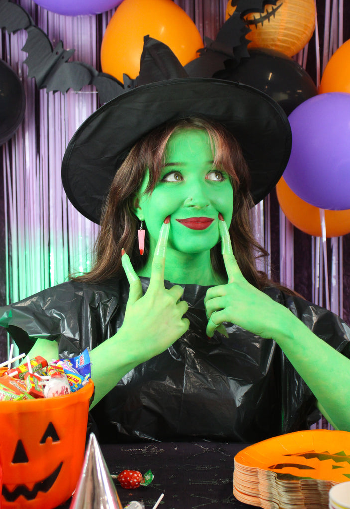 Model wearing Pink witch's finger charm on stainless steel earwires