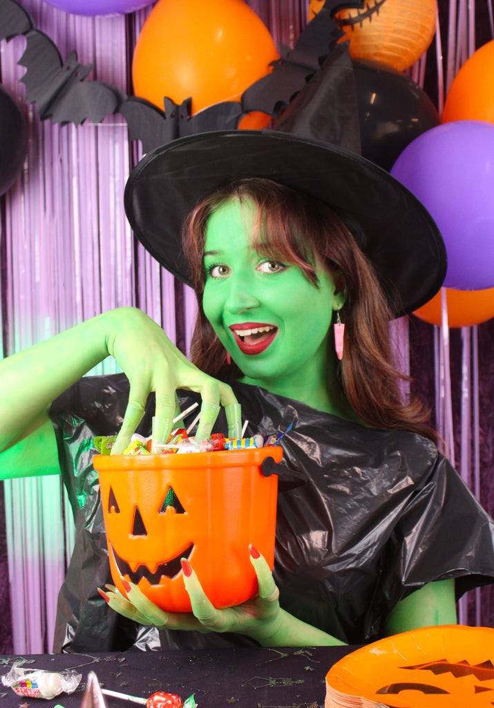 Model wearing Pink witch's finger charm on stainless steel earwires