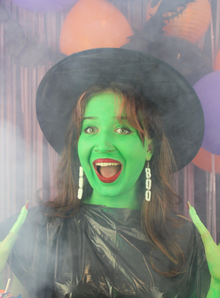 THE LETTERS B, O, O SPELLED OUT VERTICALLY WITH A WHITE DRIPPY EFFECT ON STAINLESS STEEL EARWIRES