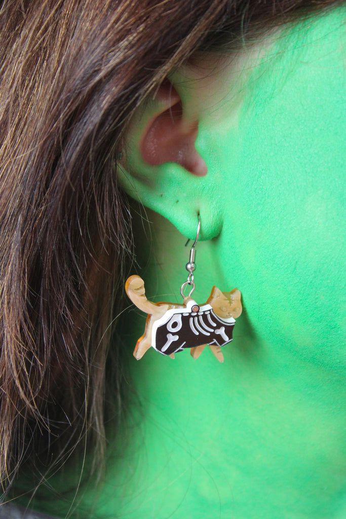model wearing ginger cat skeleton charms on stainless steel earwires 