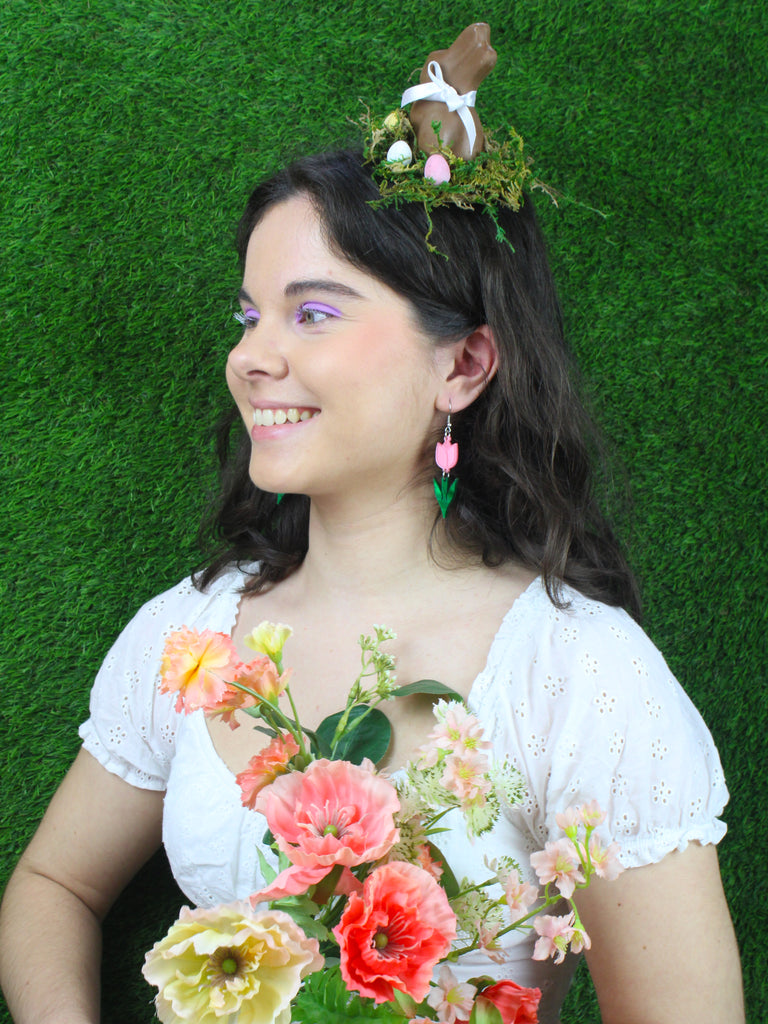 Model wearing Pink acylic tulip charms with green stems on stainless steel earwires