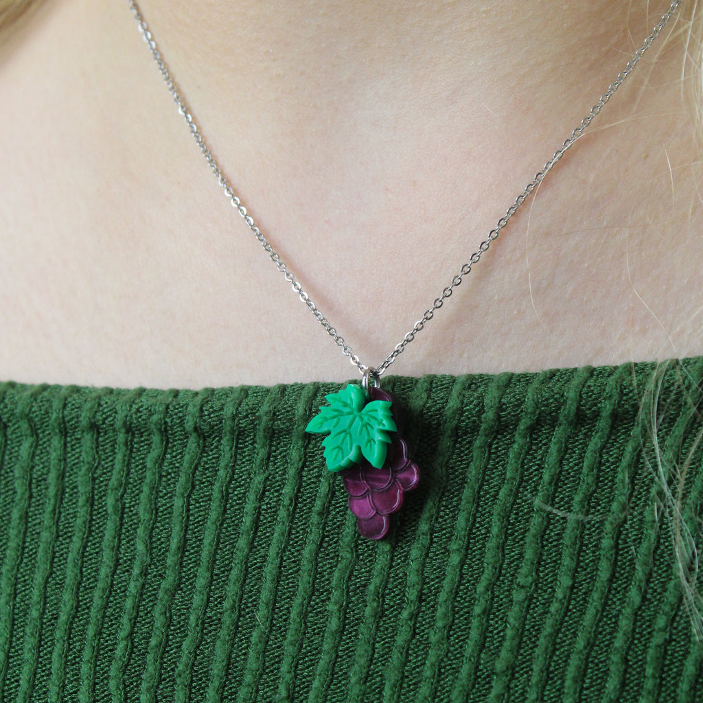 Model wearing necklace featuring purple marble acrylic grapes pendant
