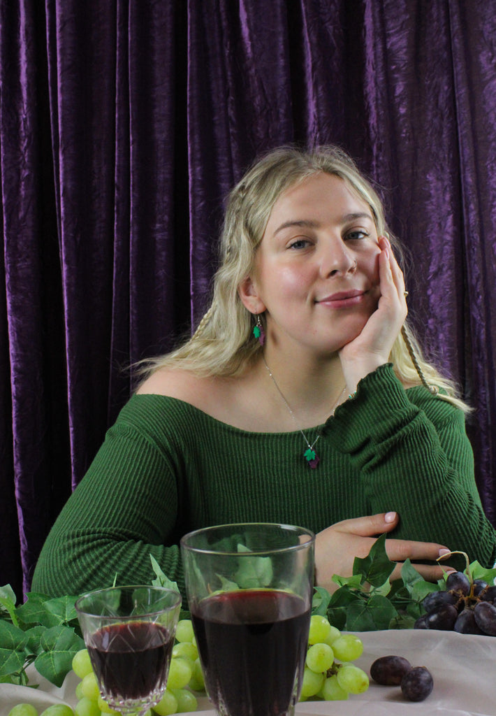 Model wearing necklace featuring purple marble acrylic grapes pendant