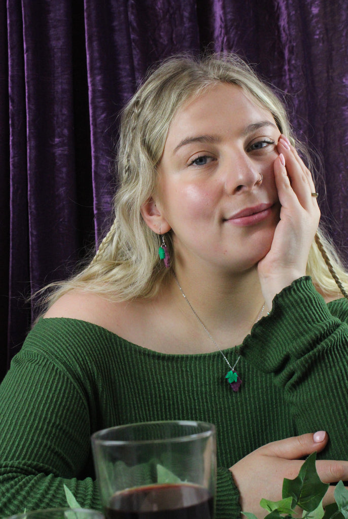  Model wearing necklace featuring purple marble acrylic grapes pendant