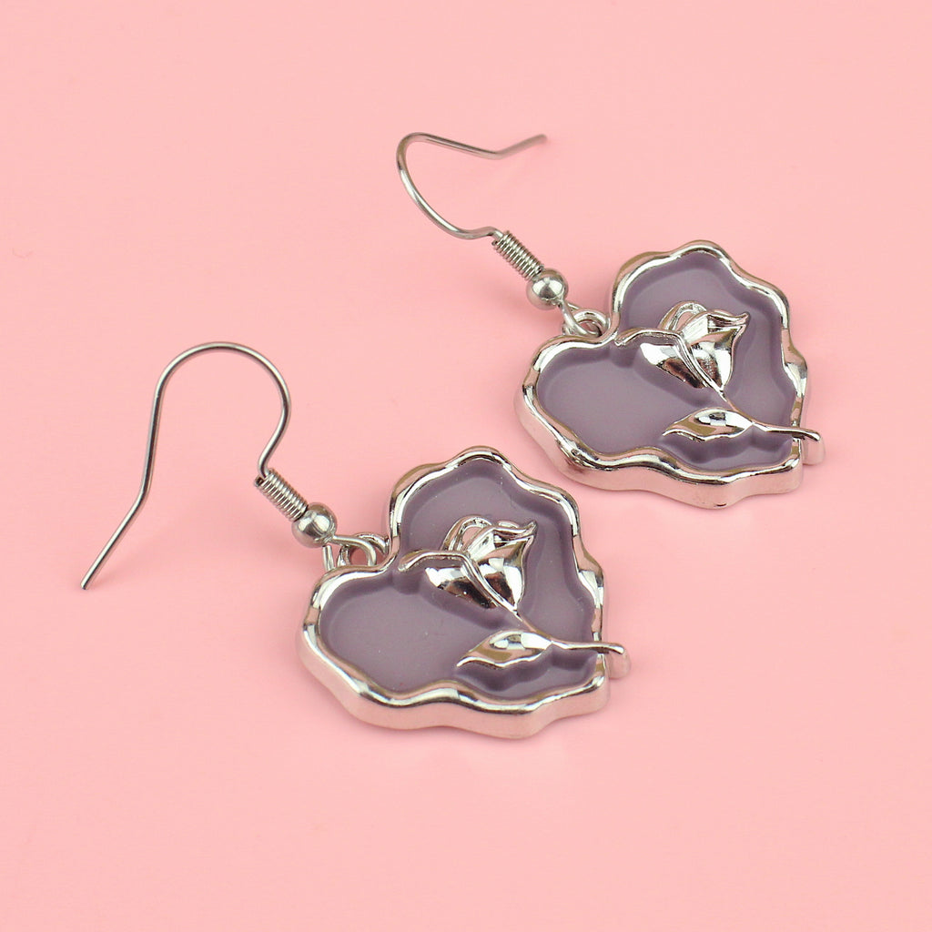a base metal charm with a beautiful rose in the centre of a purple heart, suspended from sleek stainless steel ear wires
