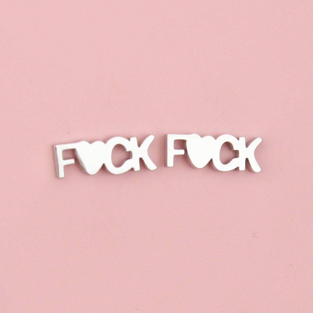 Studs with the word F*ck on with the U being replaced with a heart