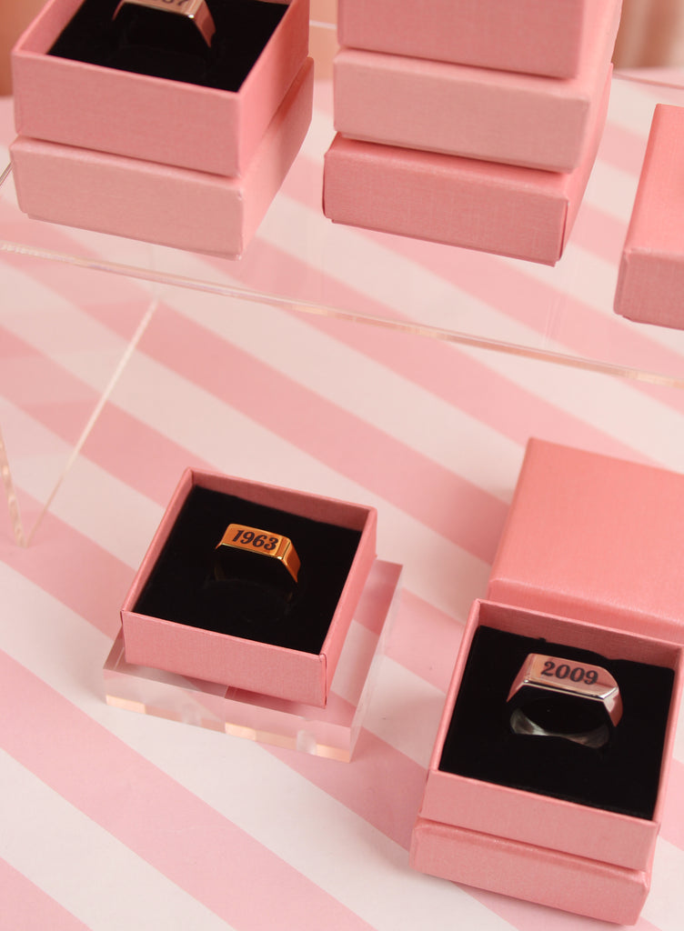 gold plated titanium with birth year engraved in black shown in a gift box