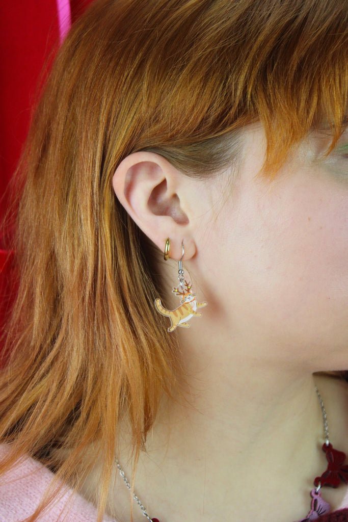 Close-up of a person wearing a cat earring
