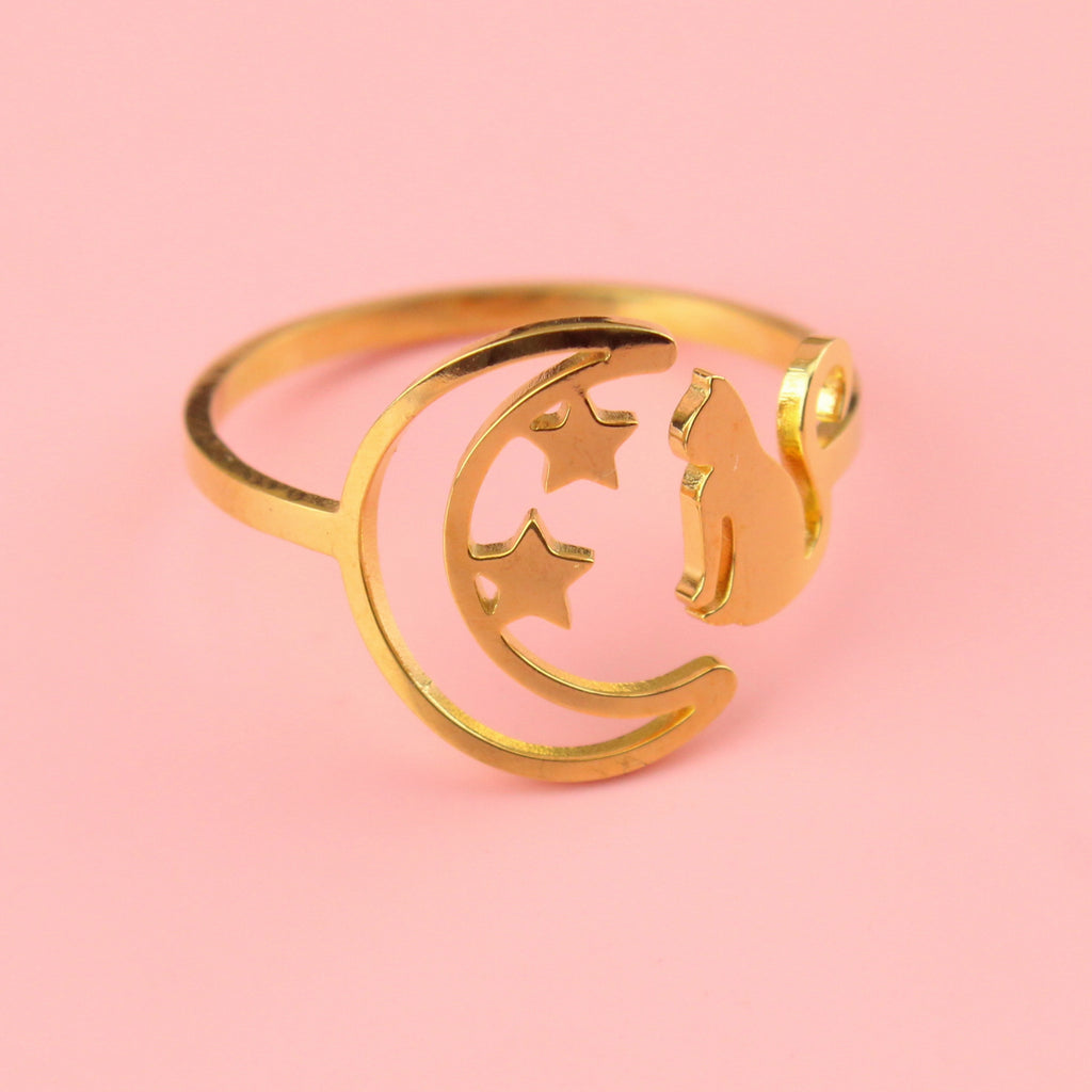 Gold plated stainless steel ring with a crescent moon on the left with 2 stars and a cat facing the moon on the right