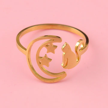 Gold plated stainless steel ring with a crescent moon on the left with 2 stars and a cat facing the moon on the right