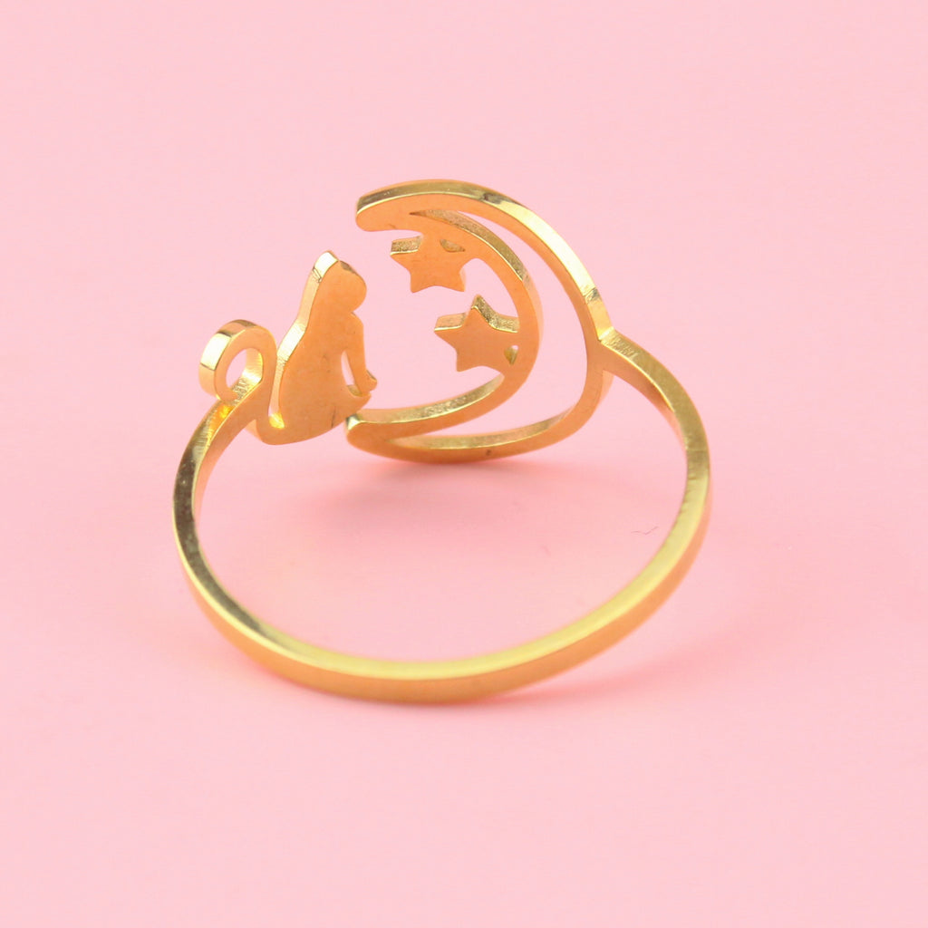 Gold plated stainless steel ring with a crescent moon on the left with 2 stars and a cat facing the moon on the right