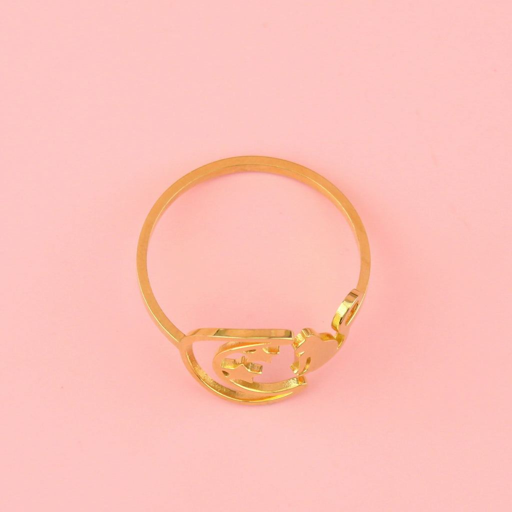 Gold plated stainless steel ring with a crescent moon on the left with 2 stars and a cat facing the moon on the right