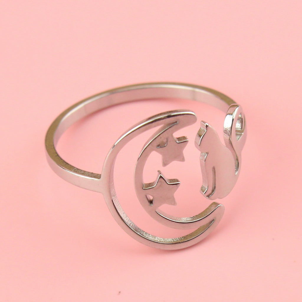 stainless steel ring with a crescent moon on the left with 2 stars and a cat facing the moon on the right