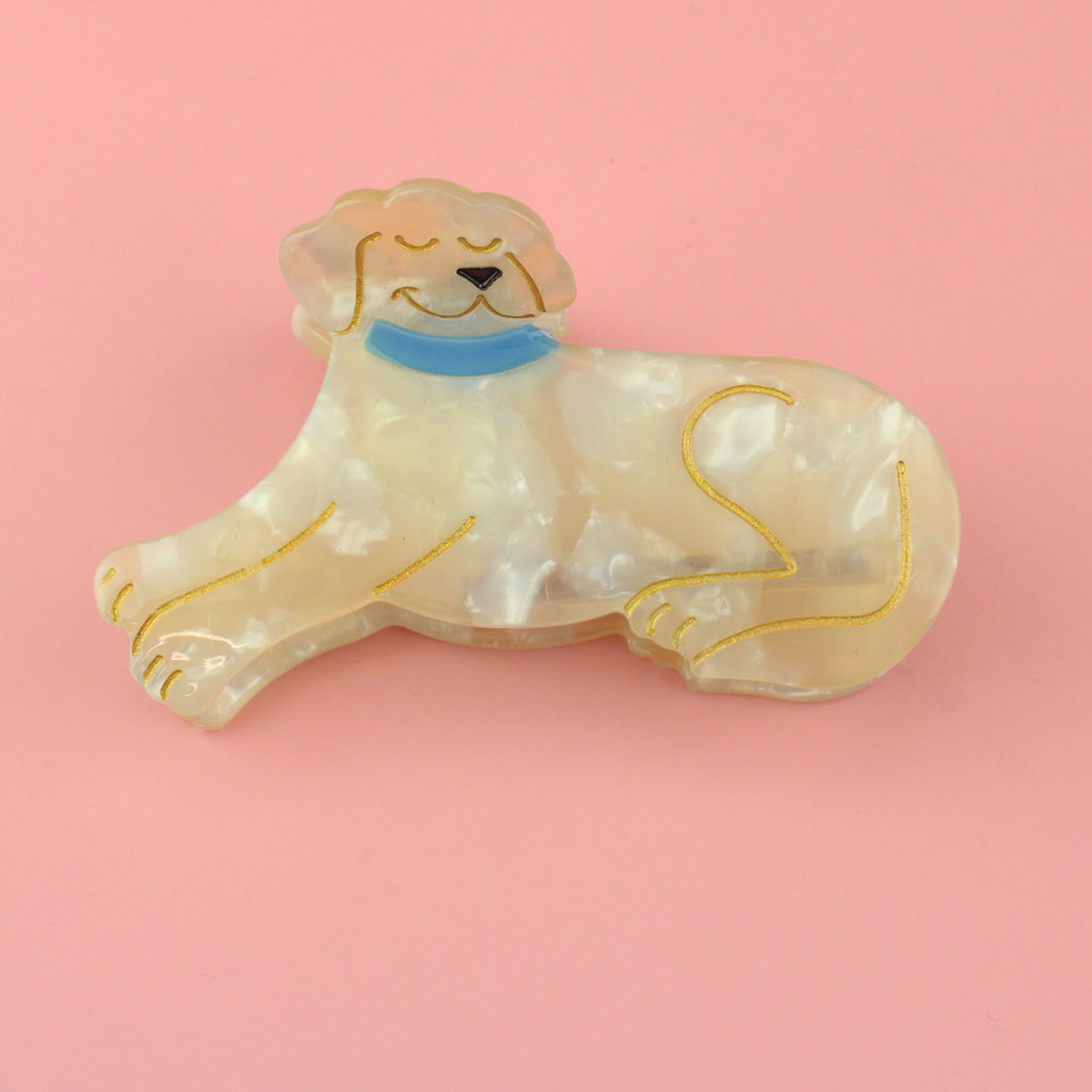 Acrylic claw clip featuring a labrador lying down with gold outlines and a blue collar