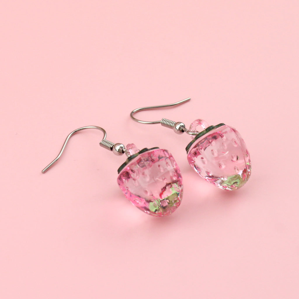 Translucent pink strawberry charm on stainless steel earwires