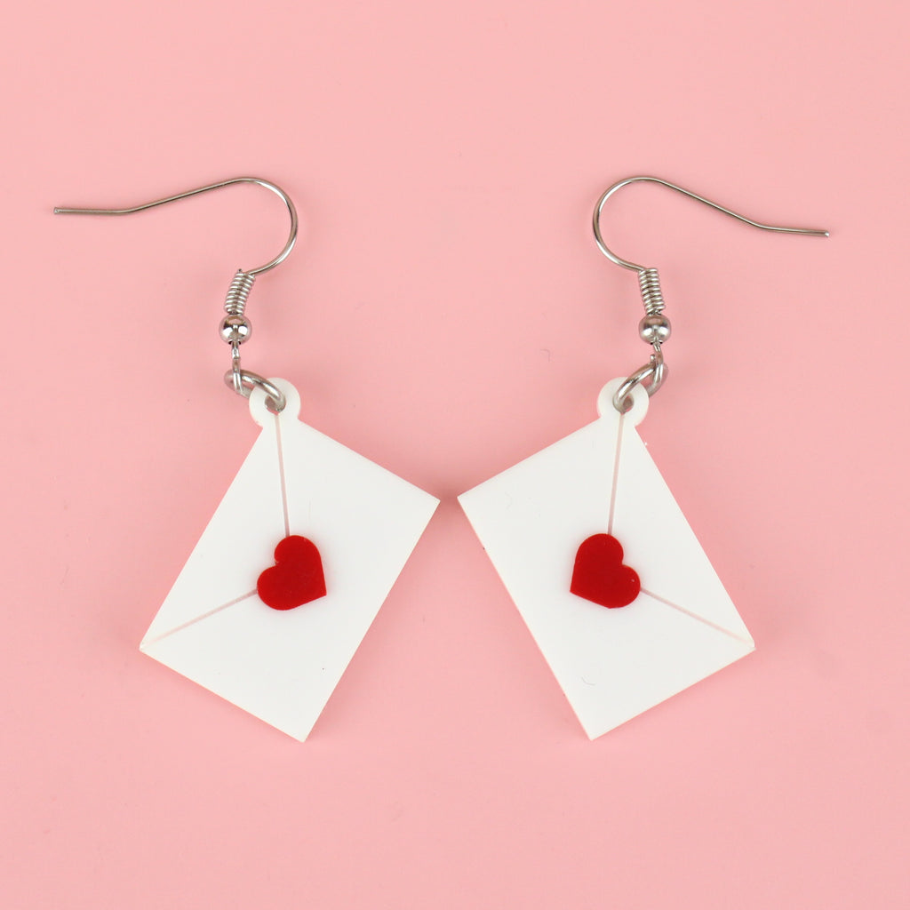 White envelope charms sealed with a red heart on stainless steel earwires