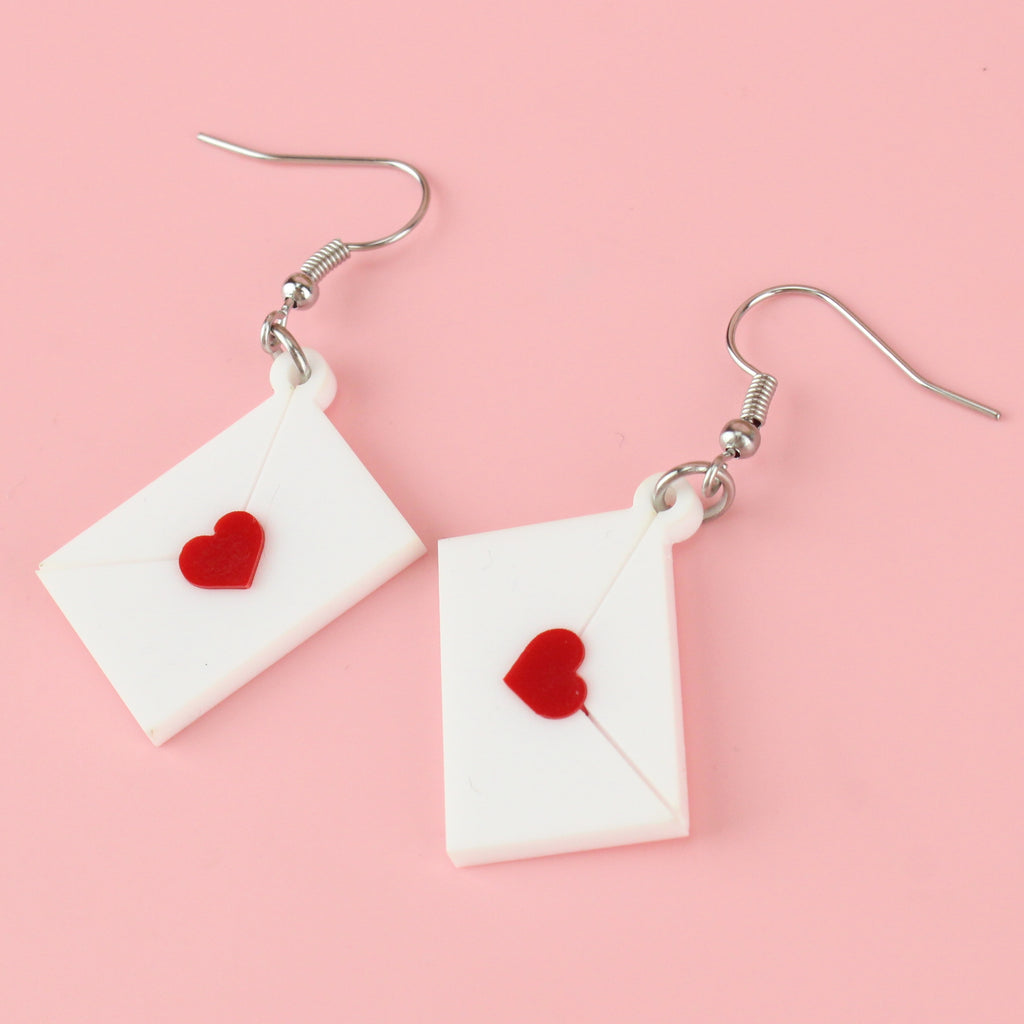 White envelope charms sealed with a red heart on stainless steel earwires