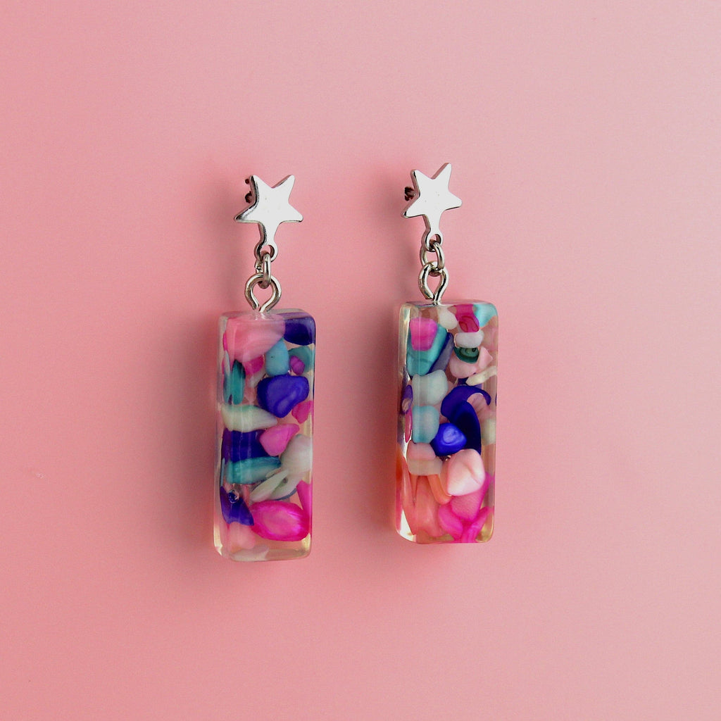A resin shell with blue, purple and pink stones inside on star shaped studs