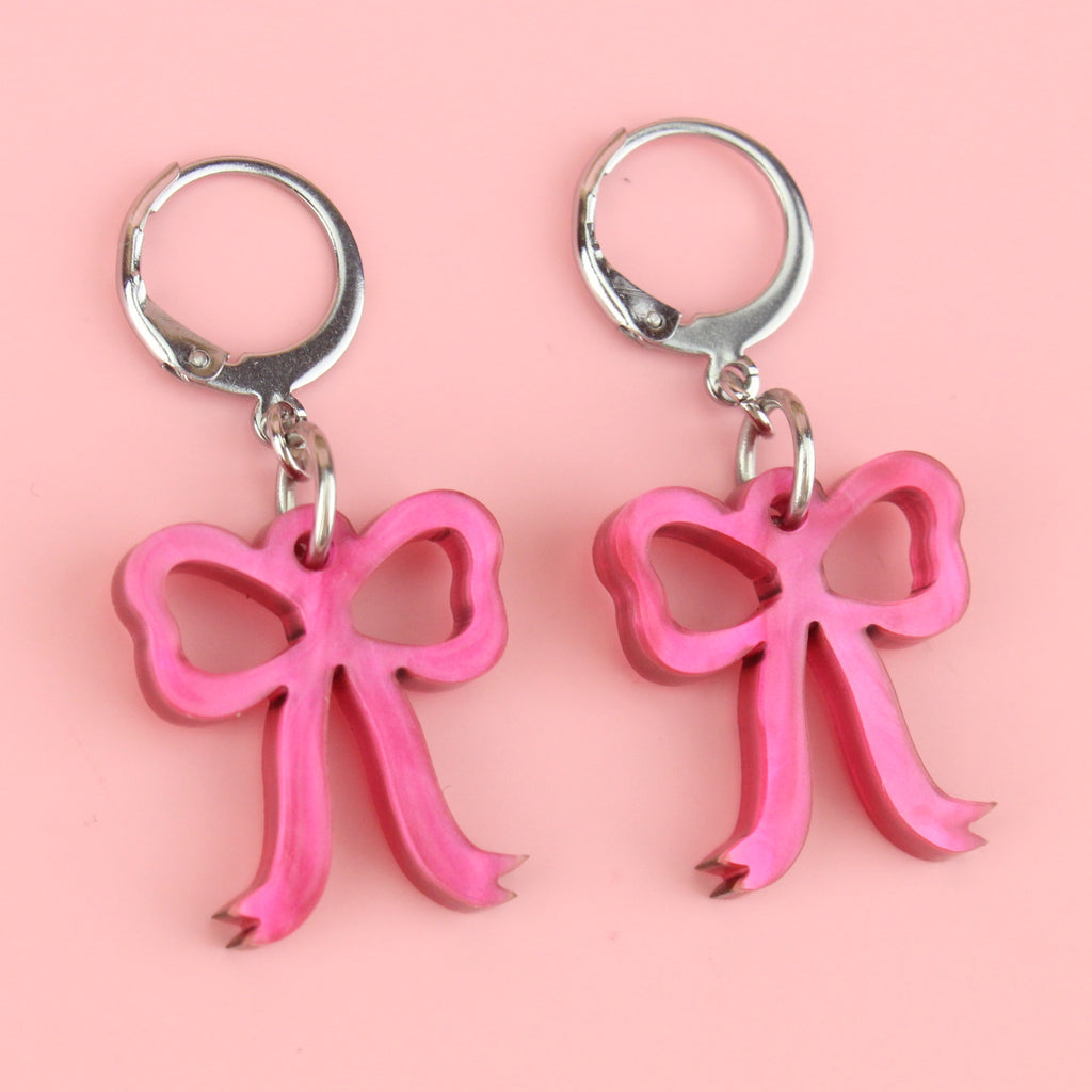 Mini pink marble bow charms on stainless steel huggie hoops