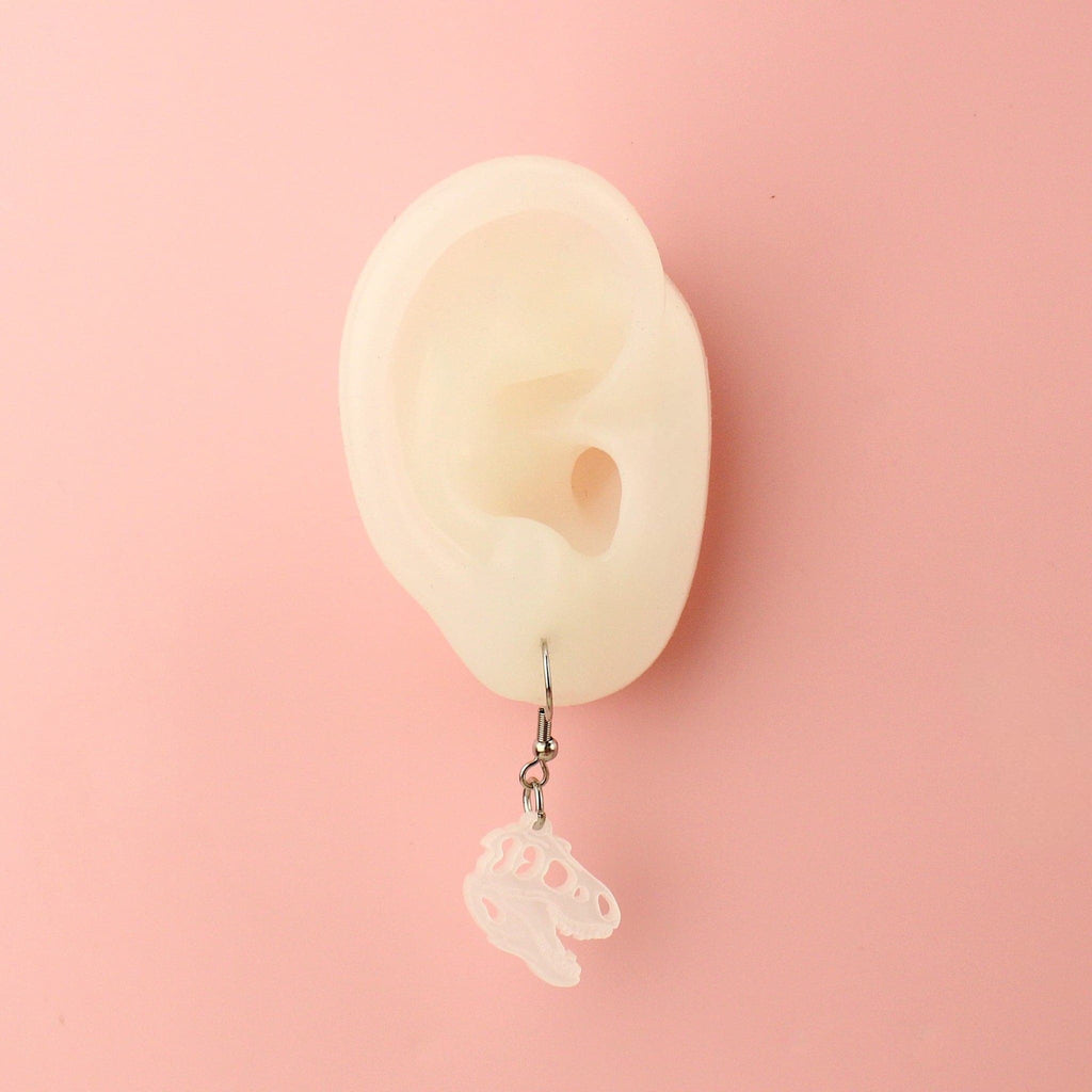 Ear wearing Mini T-Rex Skull Earrings