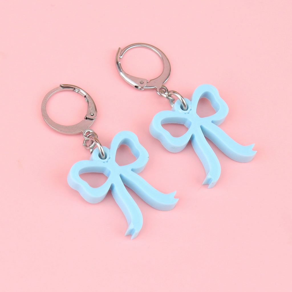 Baby blue bow charms on stainless steel huggie hoops