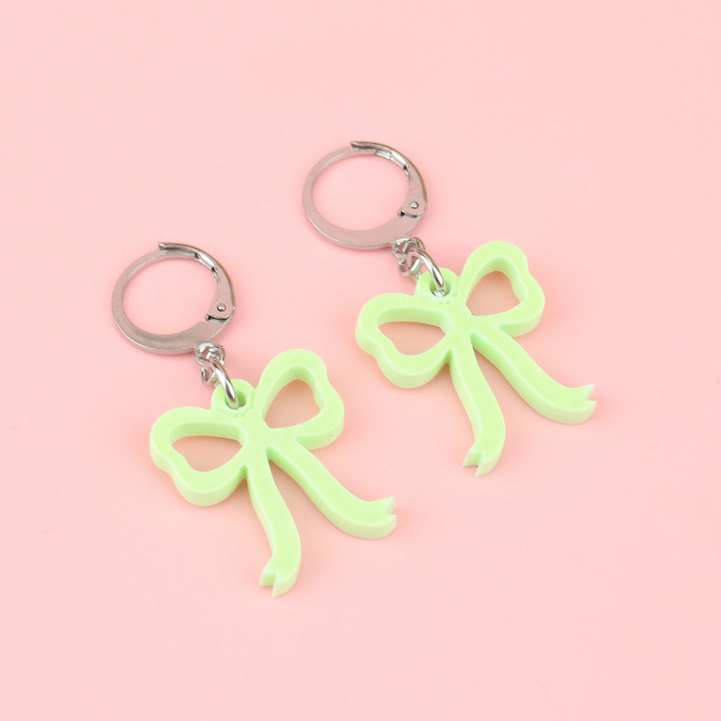 Green bow charms on stainless steel huggie hoops