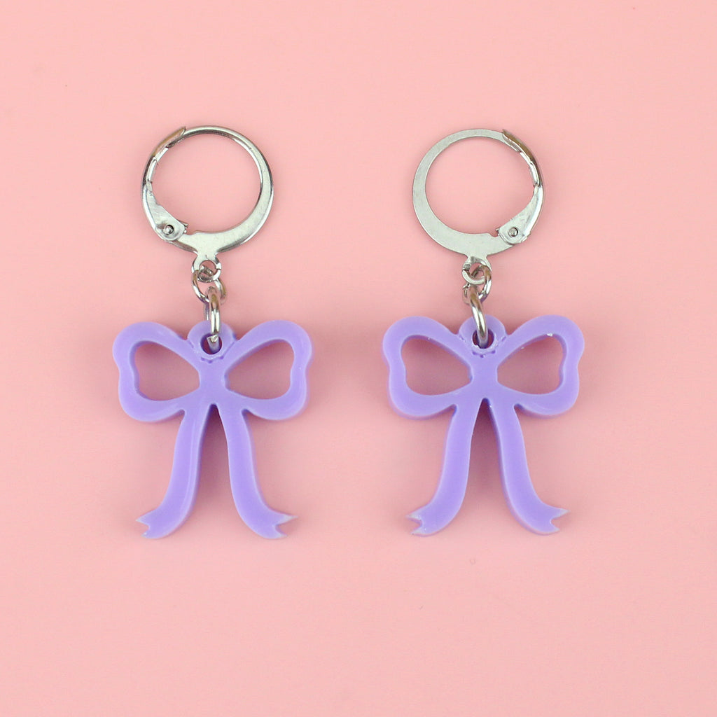 Lilac coloured bow charms on stainless steel huggie hoops