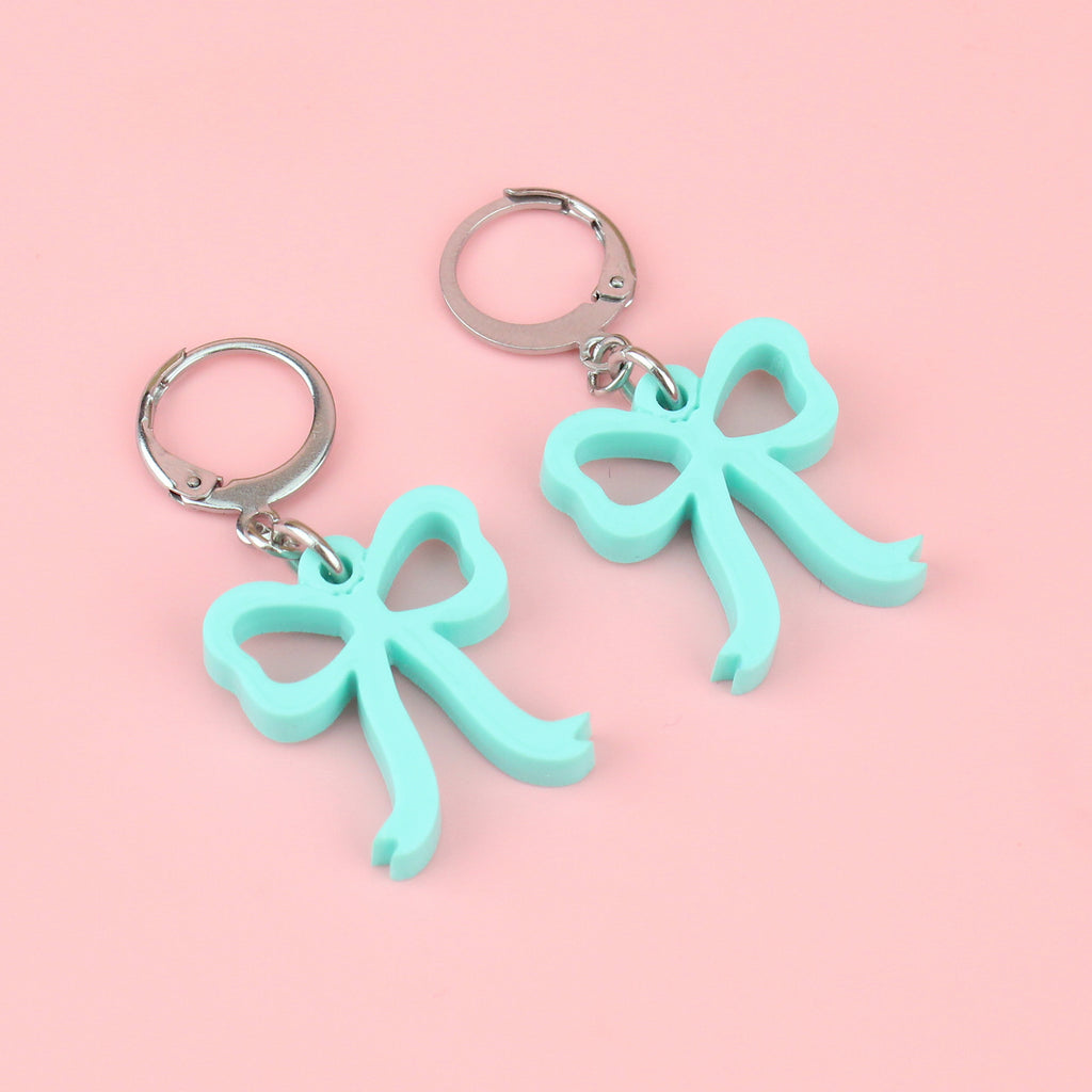 Turquoise bow charms on stainless steel huggie hoops