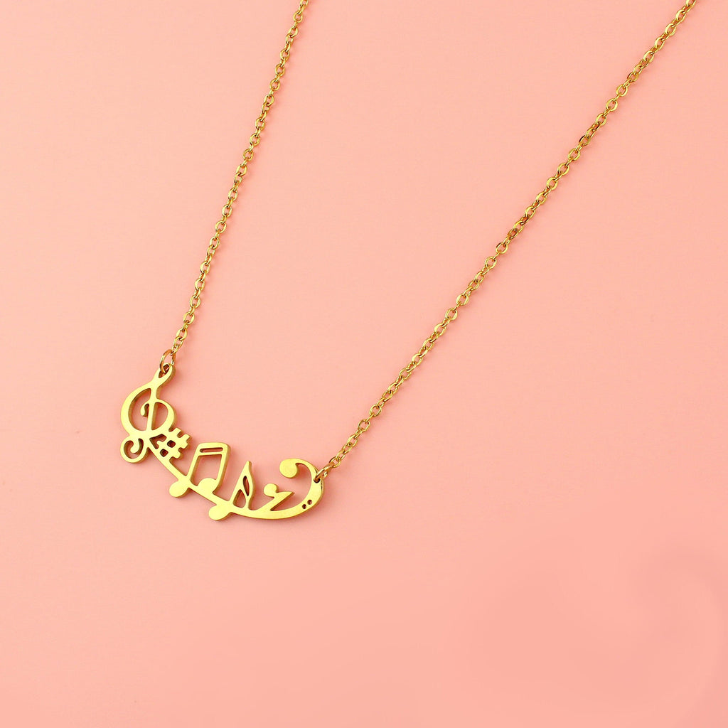 Gold plated stainless steel necklace with music notes including a treble clef, sharp and a semiquaver