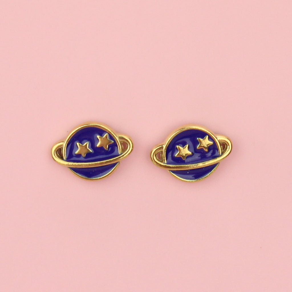 Gold plated stainless steel neptune planet stud earrings with blue enamel and two gold stars on the top half of the planet