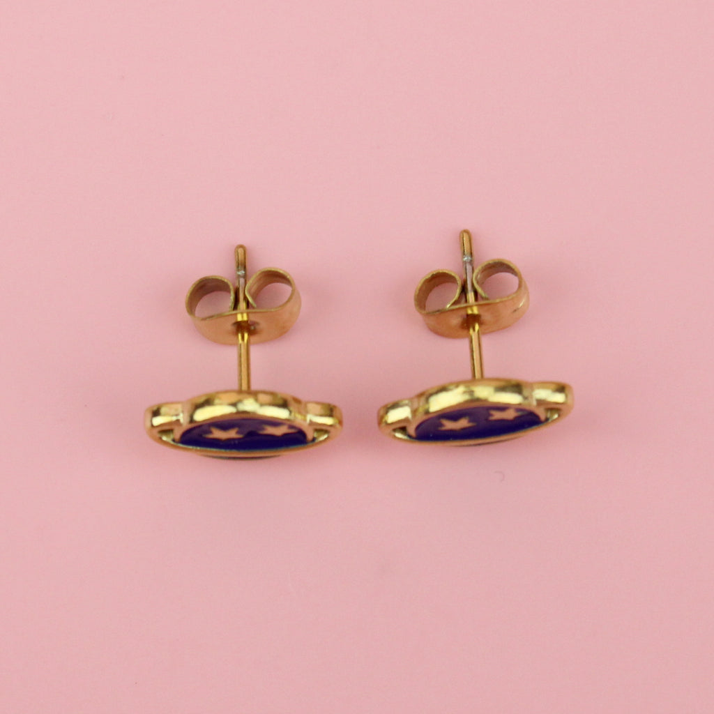 Gold plated stainless steel neptune planet stud earrings with blue enamel and two gold stars on the top half of the planet