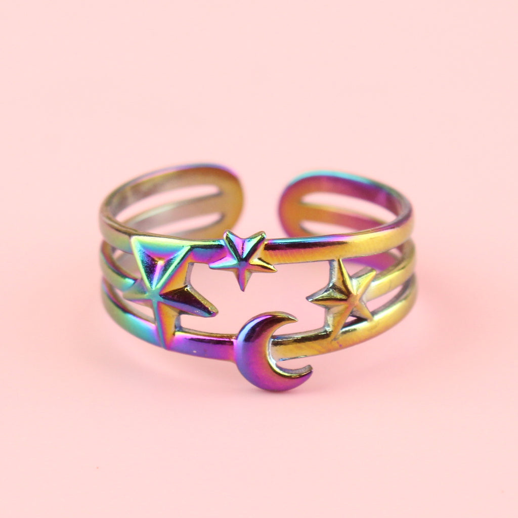 Triple ring effect made with rainbow-tinted stainless steel with a large star on the left, small in the middle and medium sized star on the right with a moon beneath the middle star