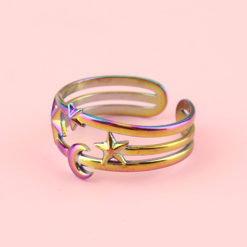 Triple ring effect made with rainbow-tinted stainless steel with a large star on the left, small in the middle and medium sized star on the right with a moon beneath the middle star