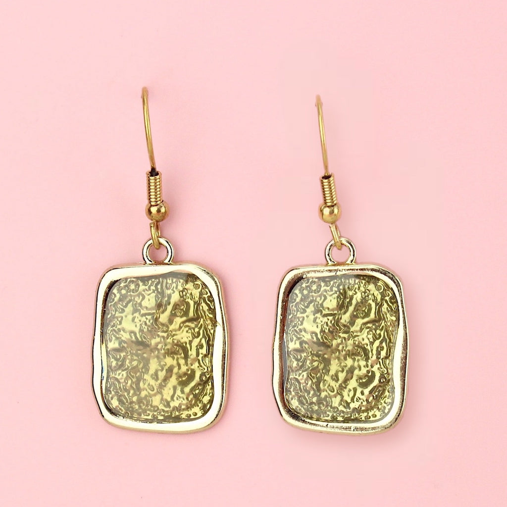 Gold rectangular shaped earrings with a wavy outline and a shimmery olive coloured centre