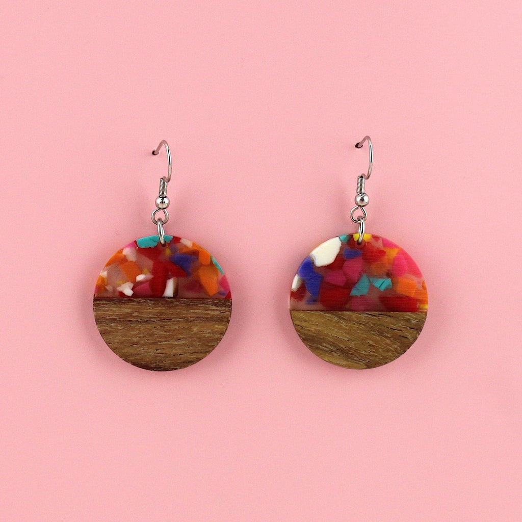 Confetti-filled resin semi-circles, set in walnut wood and hung from stainless steel earwires.