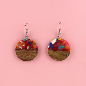 Confetti-filled resin semi-circles, set in walnut wood and hung from stainless steel earwires.