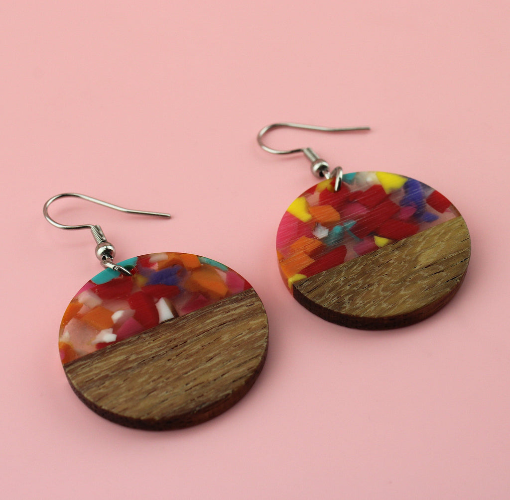 Confetti-filled resin semi-circles, set in walnut wood and hung from stainless steel earwires.