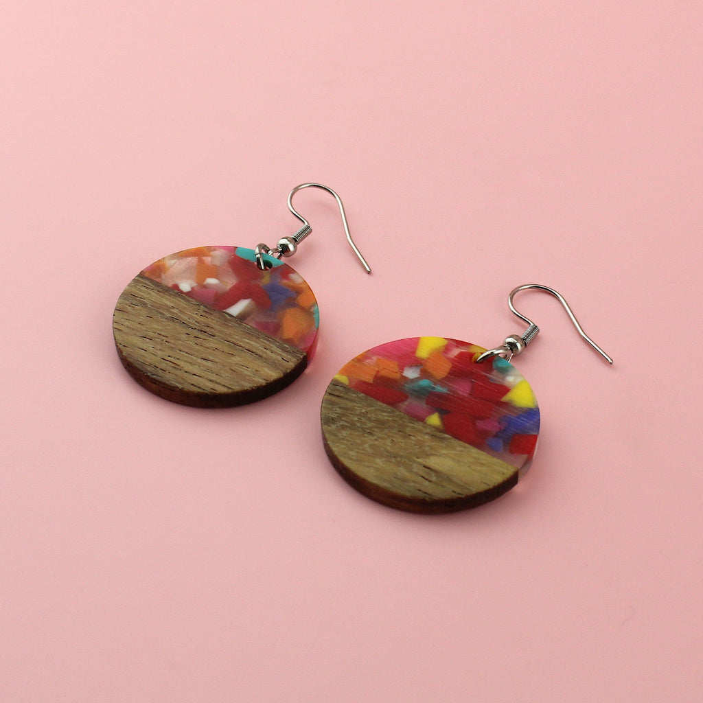 Confetti-filled resin semi-circles, set in walnut wood and hung from stainless steel earwires.