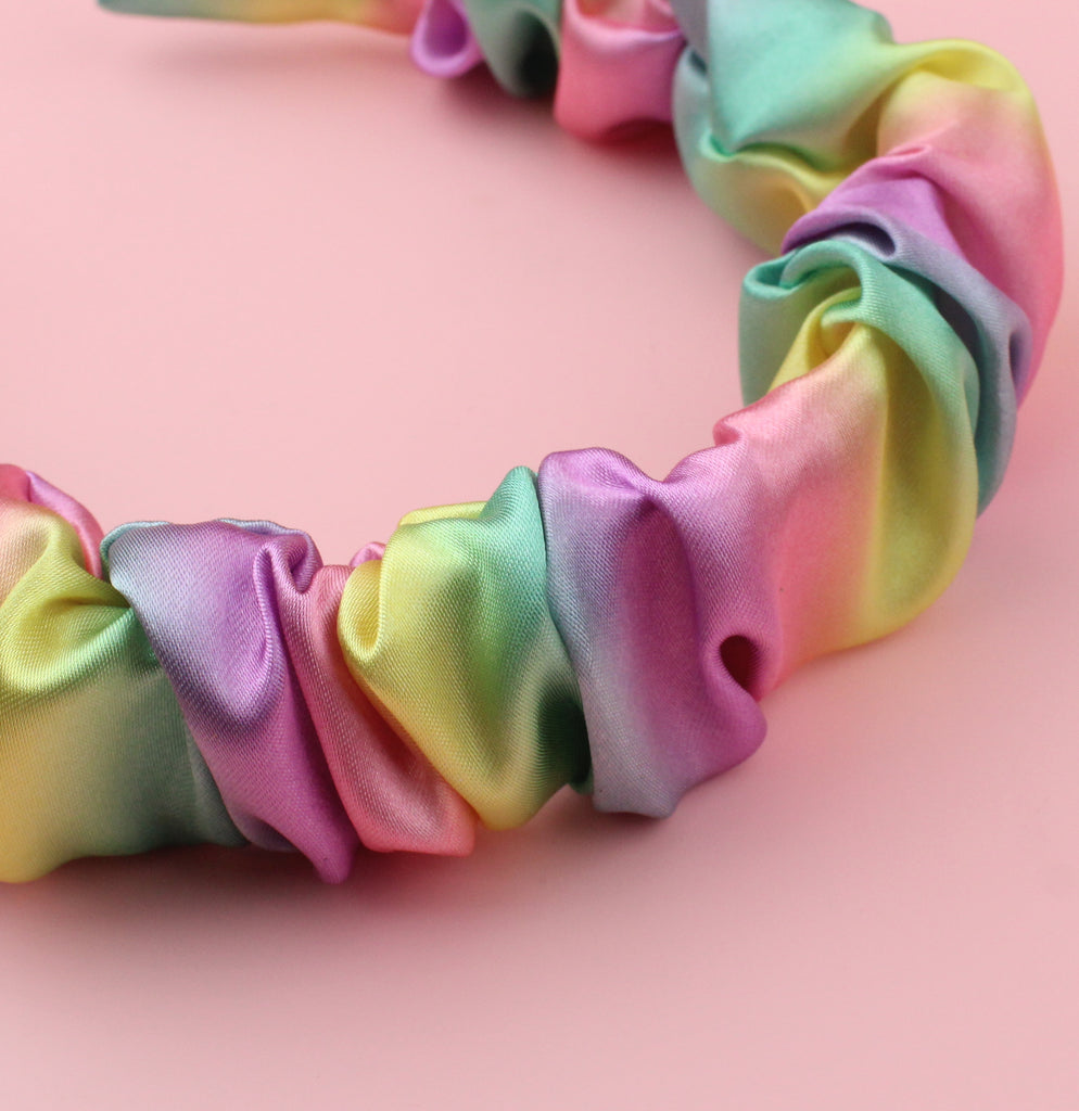 Satin scrunchie style headband with pastel yellow, pink, purple, green and blue colours