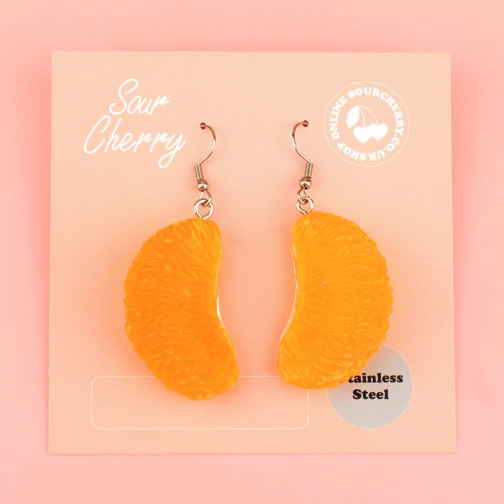 Resin satsuma segment charms on stainless steel earwires shown on the card