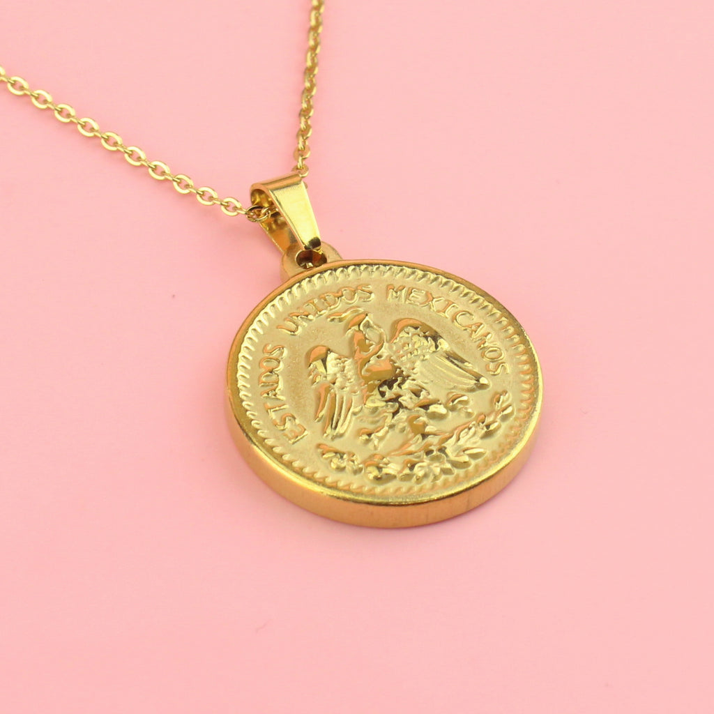 Pesos style pendant on a gold plated stainless steel chain